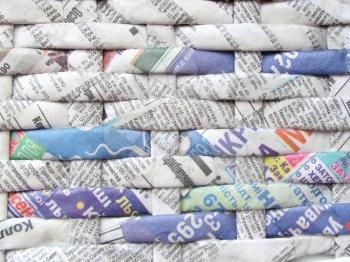 Twisted weaving newspapers. Abstract textured background. Cyrillic letters.