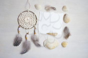 Seashells frame on wooden background with place for text. Card for a beach party, invitation, advertising. Dreamcatcher.