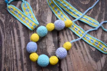 Necklace made from knitted beads and toys for the baby sitting in a sling. Knitted beads. Sling necklace.