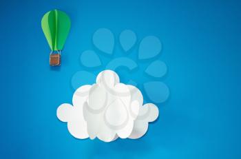 Handmade hot air balloon and cloud in the sky. Paper art style. Isolates on blue background. Blank for motivating quote, note, message and comment. Idea for poster, banner, flyer.