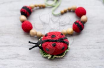 Necklace made from knitted beads and toys for the baby sitting in a sling. Knitted beads. Sling necklace.