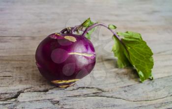 Purple kohlrabi on wooden background. Vegetable photo.