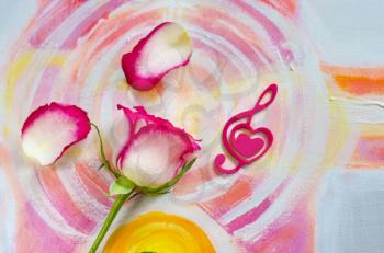 Rose with a decorative heart in the shape of a treble clef with pink felt on the background of painting. Valentine's day, mother's day congratulation.
