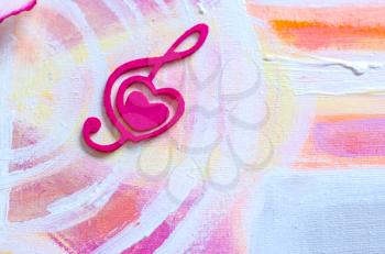 Treble clef with a heart on a beautiful background.Treble clef with a heart on a beautiful background.Photo background to Valentine's Day. Acrylic painting.