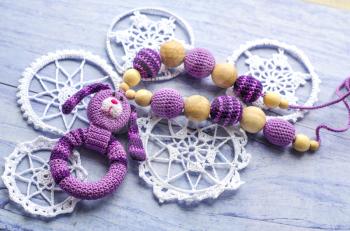 Necklace made from knitted rabbit and toys for the baby sitting in a sling. Sling necklace.