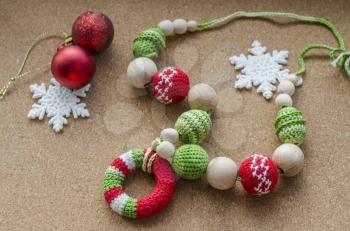 Hooked beads with ornament in red-green colors. Composition with New Year's decor.