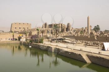 A pond near the ancient Egyptian buildings and ruins.