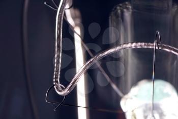 Tungsten filament in an incandescent lamp, macro photo