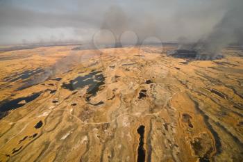 tundra fire. Burning dry grass and peat bogs, fire and smoke in the tundra.