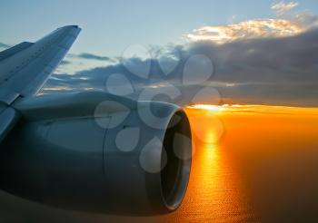 The view from the window of a passenger plane during the flight, the wing of the turbine engine of the aircraft.