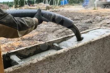 Pouring foam into the formwork to create walls
