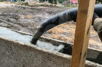 Pouring foam into the formwork to create walls
