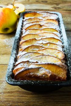 Apple tart with fresh fruits and caster sugar. Puff pastry fruit dessert pie, selective focus 