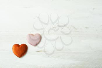 Two silk hearts on a white wooden background, Valentines Day background, wedding day background, top view
