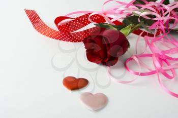 Valentines Day background, wedding day background, rose, red and pink ribbon, silk hearts on white background