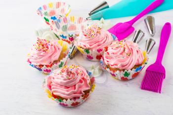 Pink cupcakes  and kitchen utensils. Birthday cupcakes. Homemade cupcake. Sweet dessert. Sweet pastry.  Gourmet cupcakes. Sweet cupcake. 