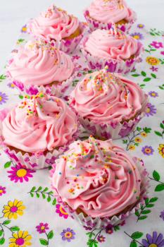 Pink cupcakes  on floral pattern napkin. Homemade cupcake. Sweet dessert. Sweet pastry.  Gourmet cupcakes. Sweet cupcake. Birthday cupcakes. 