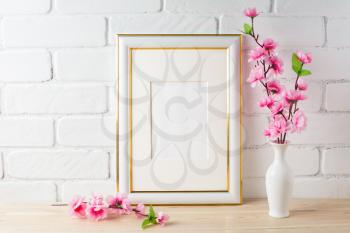 White frame mockup with pink flower bunch. Empty white frame mockup for design presentation. Portrait or poster white frame mockup romantic style.