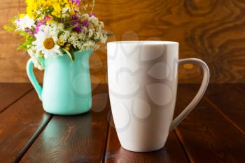 Coffee mug mockup with mint green flowerpot. Coffee cup mock-up for brand promotion.  Empty mug mockup for design presentation.