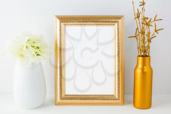 Frame mockup with golden vase and ivory hydrangea. Empty white frame mockup for design presentation. Portrait or poster  frame mockup.