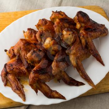 Fried chicken wings, crispy chicken wings grilled on a white plate