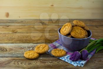 Sesame cookies in the purple bowl on the linen napkin. Breakfast cookie. Dessert cookies. Cookies. Cookie. Dessert. Breakfast. Sweet cookie. Homemade cookies.  