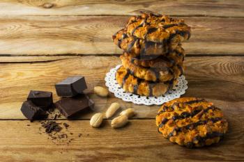 Stack of homemade chocolate peanut cookies on a rustic wooden table