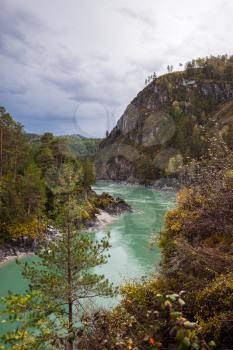 Vertical view of the turquoise river flowing between the rocks of the mountains, Katun river, Altai Mountains, Russia
