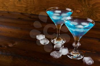 Blue cosmopolitan cocktail with ice. Blue margarita. Blue cosmopolitan. Blue Lagoon. Blue cocktail. Blue Martini. Blue Hawaiian cocktail. Blue curacao liqueur. 