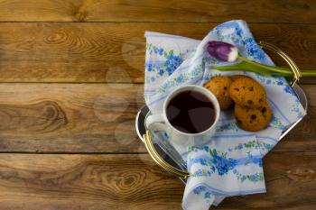Breakfast tea in serving tray on wooden background. Homemade biscuit. Homemade cookies.Sweet dessert. Breakfast cookies. Sweet pastry. Cup of tea. Tea cup. Breakfast tea. 