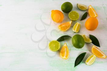 Citrus fruits mix on light green background. Healthy eating concept with lime and lemon. Fresh vegetarian food. Fresh mixed fruit. Fruit background. 