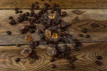 Coffee grains on the wooden background. Coffee grains. Coffee beans. Morning coffee. Coffee background. 