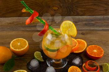 Cool citrus cocktail on wooden table. Fruit cocktail. Fruit drink. Citrus lemonade. Fruit lemonade. Summer drink 