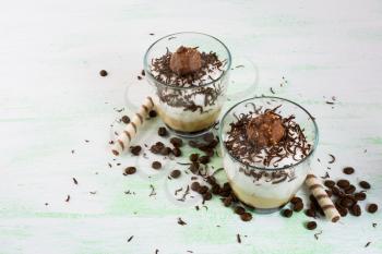 Creamy coffee Chocolate cocktail in glasses on light green background. Coffee dessert with cocoa. 