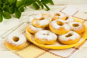 Donuts powdered by caster sugar. Doughnuts. Sweet pastry. Donuts. Sweet dessert. 