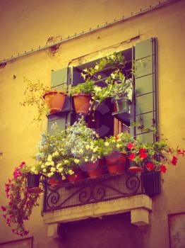 Flowers decoration in Venice, Italy. Vintage toned. Flower pots outside window. Summer flowers.