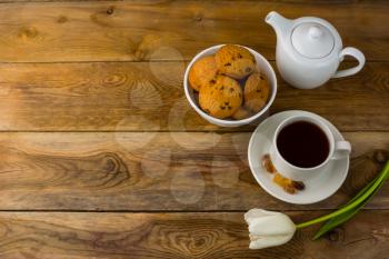 Tea cup, cookies  and teapot on wooden background, copy space. Breakfast tea. Homemade cookiesCup of tea. Tea cup.
