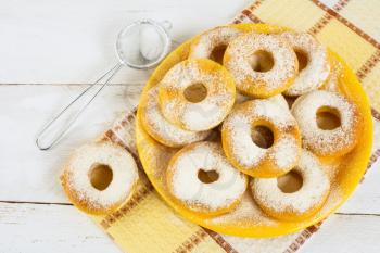 Homemade donuts on yellow plate. Sweet dessert. Sweet pastry. Doughnuts.  Donuts.