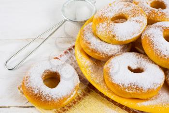 Homemade donuts powdered by caster sugar. Doughnuts. Sweet pastry. Donuts. Sweet dessert. 