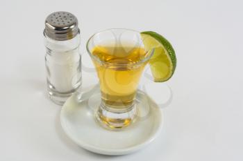 Tequila with lime on the white background. Tequila shot. Gold Mexican tequila. Tequila