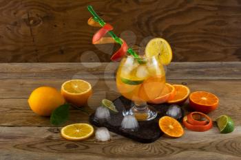 Tropical fruit cocktail on wooden table. Fruit cocktail. Fruit drink. Summer drink. Citrus lemonade. Fruit lemonade.