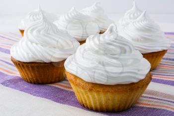 White cupcakes on the linen napkin. Sweet pastry.  Sweet dessert. Birthday cupcakes. Homemade cupcake. Sweet cupcake. Gourmet cupcakes. 