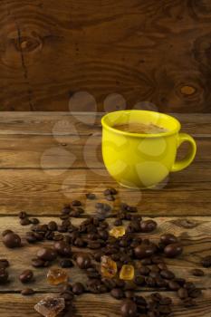 Yellow mug of strong coffee and brown sugar. Coffee cup. Morning coffee. Strong coffee