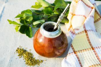 Yerba mate in gourd calabash with bombilla. Traditional Latin America herbal tea in mate calabash with special mate drinking straw bombilla. 