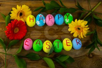 Easter eggs and leaves on a dark wooden background. Easter background. Easter eggs. Easter. Easter symbol.  Easter card. Easter greetings. Happy Easter