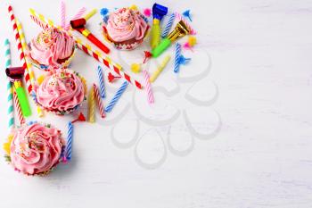 Birthday background with pink cupcakes. Sweet gourmet pastry dessert. Homemade cupcakes with whipped cream.  
