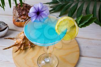 Blue tropical sea holidays cocktail. Blue Lagoon margarita martini cocktail. Summer beach alcohol drink.  Iced blue Hawaiian cosmopolitan cocktail.