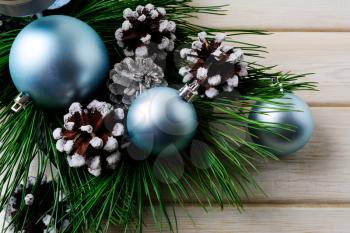 Christmas background with blue ornaments and decorated pine cones. Christmas party decoration.