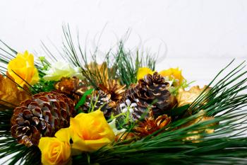 Christmas decoration with golden fir cones on white background. Christmas greeting with golden decor. Copy space. 