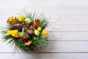 Christmas table centerpiece with pine branches and golden fir cones. Christmas background with golden decor. Copy space.